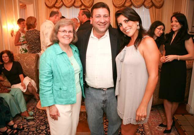 Holly Petraeus (left) with Scott Kelley (center) and Jill Kelley (right) at a party.   