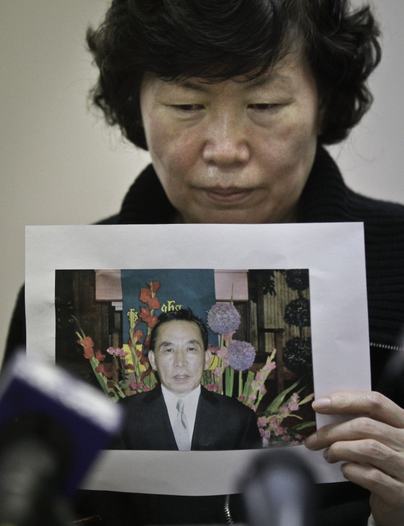 Serim Han holds a picture of her deceased husband Ki Suk Han