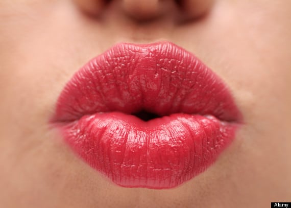 Lips of a Female Wearing Bright Red Lipstick Close Up