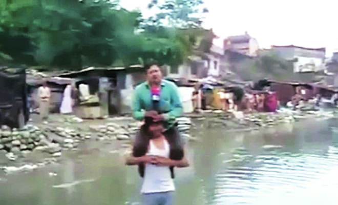 Indian Tv Reporter Fired After Reporting News Sitting On Flood Victims Shoulder 7749