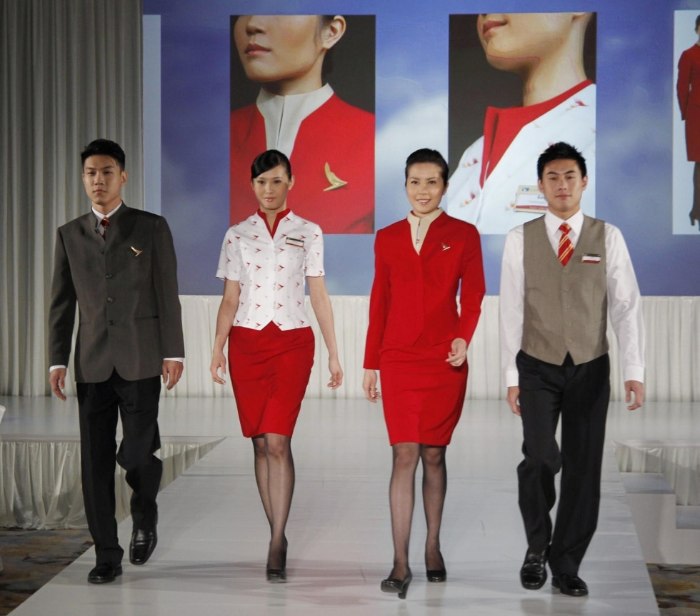Cathay Pacific air stewardesses complain uniform is too revealing.