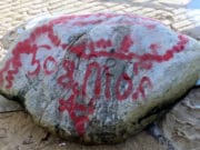 Who? Plymouth Rock defaced w/ red graffiti Plymouth Rock red graffiti