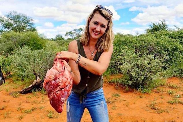 South African hunter poses with giraffe heart